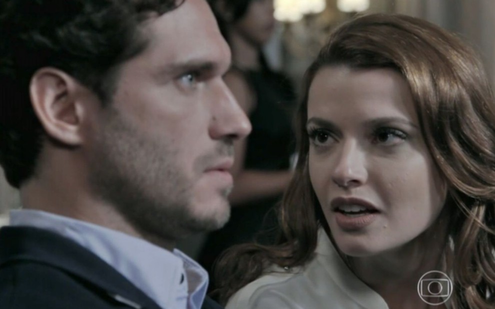 Sentada, Helena (Júlia Fajardo) conversa com Orville (Paulo Rocha) durante leilão em Império