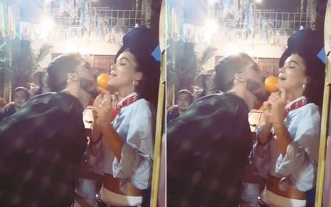 João Guilherme segura uma laranja com a boca contra o rosto de Bruna Marquezine em brincadeira junina