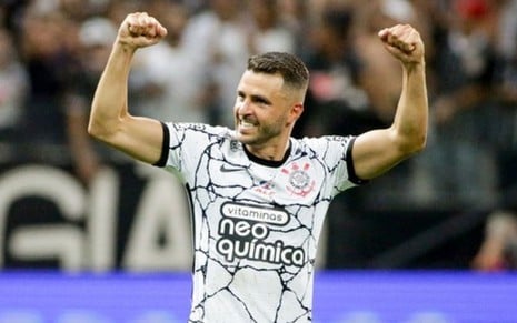 Junior Moraes, do Corinthians, comemora com braços para o alto vestindo uniforme branco com detalhes pretos