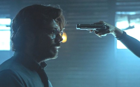 Álvaro Morte com uma arma apontada para a cabeça em cena de La Casa de Papel 5