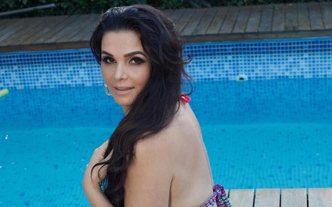 Luiza Ambiel posa perto de um piscina com os cabelos colocados de lado