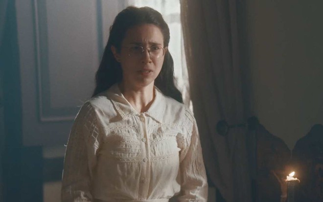 Atriz Daphne Bozaski olha para frente e faz cara de tensão em cena de Nos Tempos do Imperador