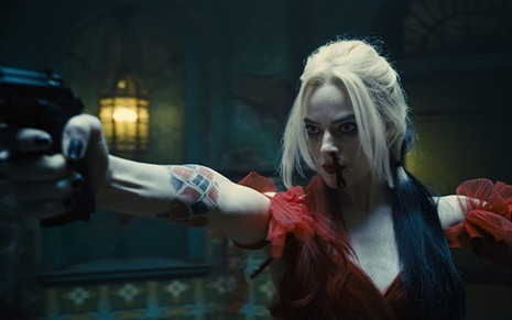Margot Robbie aponta arma em cena do filme O Esquadrão Suicida