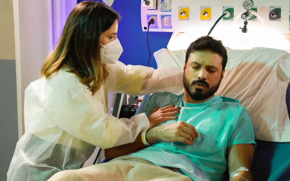 Cena de Poliana Moça: Luísa (Thaís Melchior) acode Marcelo (Murilo Cezar) , que está tossindo em cama de hospital