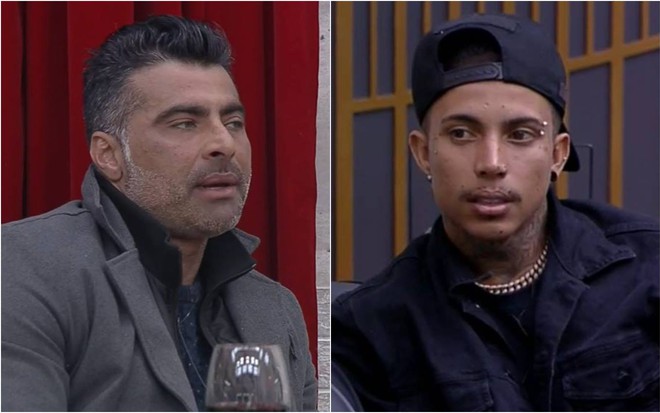 JP olha para o lado, ele usa blusa cinza e jaqueta preta; Matheus olha para o lado, usa blusa preta e boné preto