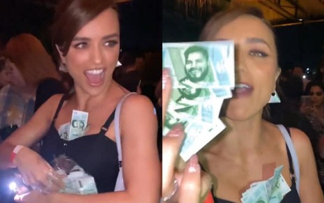 Rafa Kalimann na festa do BBB 22; ela veste um vestido preto e exibe notas de dinheiro falso com o rosto de Paulo Vieira estampado