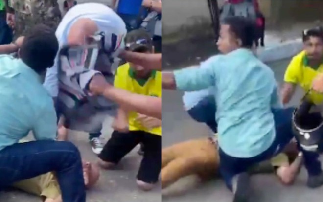 Foto de homem caído no chão enquanto outros três homens o acodem