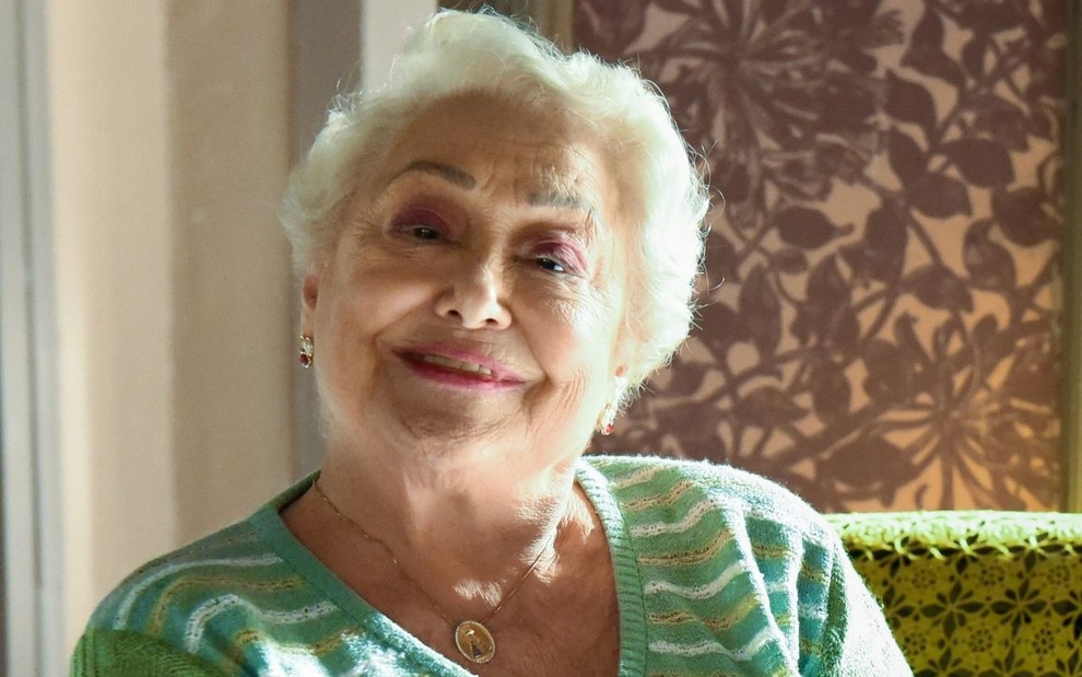 Suely Franco sorri e está caracterizada como a personagem Marlene em A Dona do Pedaço (2019)