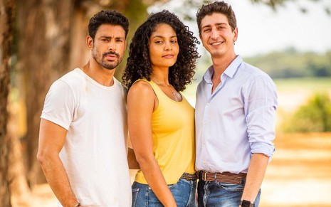 De blusa amarela, Barbara Reis posa entre Cauã Reymond, de blusa branca, e Johnny Massaro, de camisa azul clara