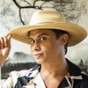 O ator Silvero Pereira como Zaquieu em Pantanal; ele está posando para foto com uma mão no chapéu e outra na cintura