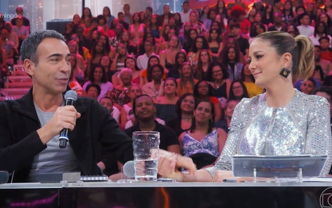 César Tralli segura a mão de Ticiane Pinheiro no Domingão com Huck, na Globo