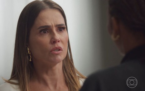 Com expressão de choro, Lara (Deborah Secco) olha para Taís (Késia) em cena de Elas por Elas