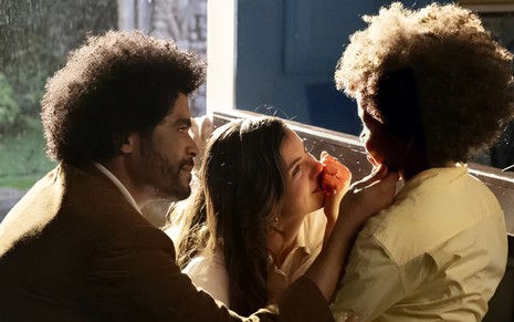 Diogo Almeida e Camila Queiroz estão ajoelhados diante de Levi Asaf em cena de Amor Perfeito