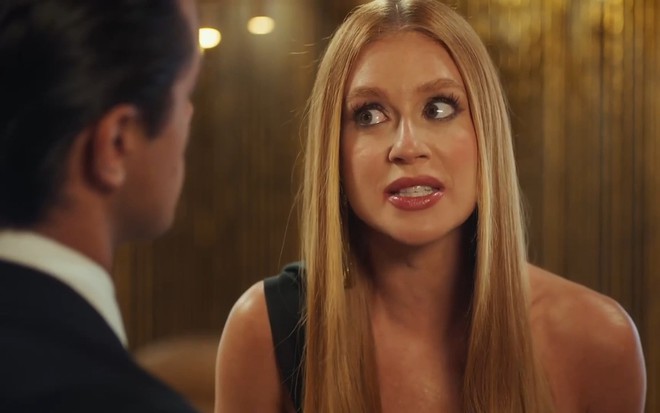 Preciosa (Marina Ruy Barbosa) com expressão irritada diante de Heitor (Felipe Simas) em cena de Fuzuê