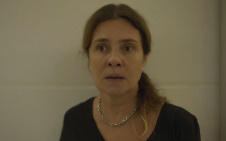 Adriana Esteves caracterizada como Cibele; ela está séria em cena de Os Outros