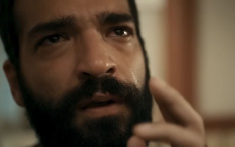 Humberto Carrão caracterizado como José Inocêncio; uma lágrima corre pelos olhos dele, que está emocionado em cena de Renascer