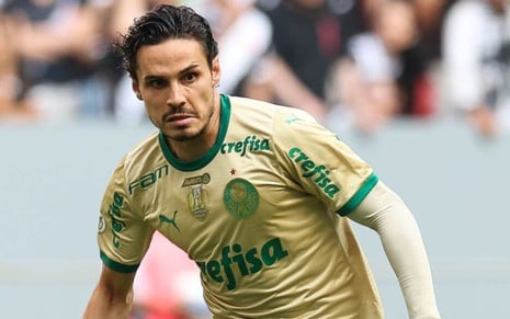 Raphael Veiga, do Palmeiras, veste uniforme dourado com detalhes em verde durante partida