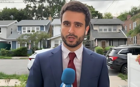 Pedro Paiva segura um microfone em reportagem ao vivo na RedeTV!