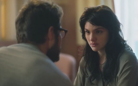 De costas na imagem, Hélio (Rafael Vitti) conversa com Petra (Debora Ozório) em cena da novela Terra e Paixão