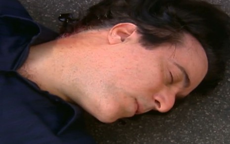 Tony Ramos desmaiado no asfalto em cena como Téo da novela Mulheres Apaixonadas