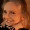 Angela Ro Ro está sorridente, com as duas mãos apoiadas na nuca