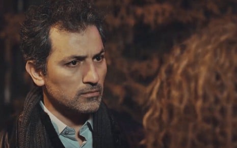 O ator Feyyaz Duman sério, em frente à atriz Seray Kaya em cena de Força de Mulher