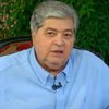 Datena em entrevista ao Sensacional; ele aparece sentado em uma cadeira, usando camisa azul-claro
