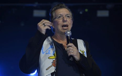 Boninho está de boca aberta e com expressão levemente nervosa em um evento