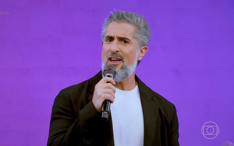 Marcos Mion segurando microfone no Caldeirão