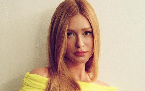 Marina Ruy Barbosa posando com feição séria, vestido amarelo, ainda com seu cabelo ruivo