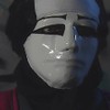 O ator Breno Moroni com máscara branca, caracterizado como o personagem Mascarado na novela A Viagem