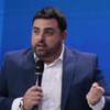 Macedão da Chinelada e Daniele Brandi falam em seus microfones durante coletiva de imprensa