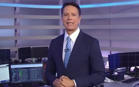 Sergio Aguiar usa terno e está em pé na Redação do Jornal da Record