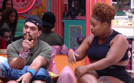 Vinícius Nascimento e Camilla Maia estão sentados no sofá da sala do BBB 25