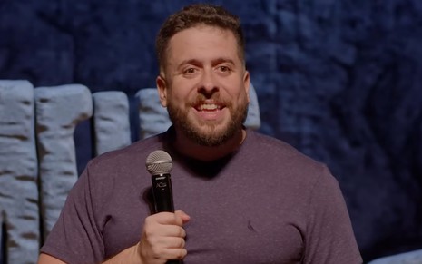 Mauricio Meirelles parece assustado no palco de um show de stand-up