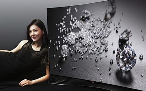 Modelo ao lado de televisor da LG que vem com 460 cristais Swarovski, lançado em feira na Alemanha - Fotos Divulgação