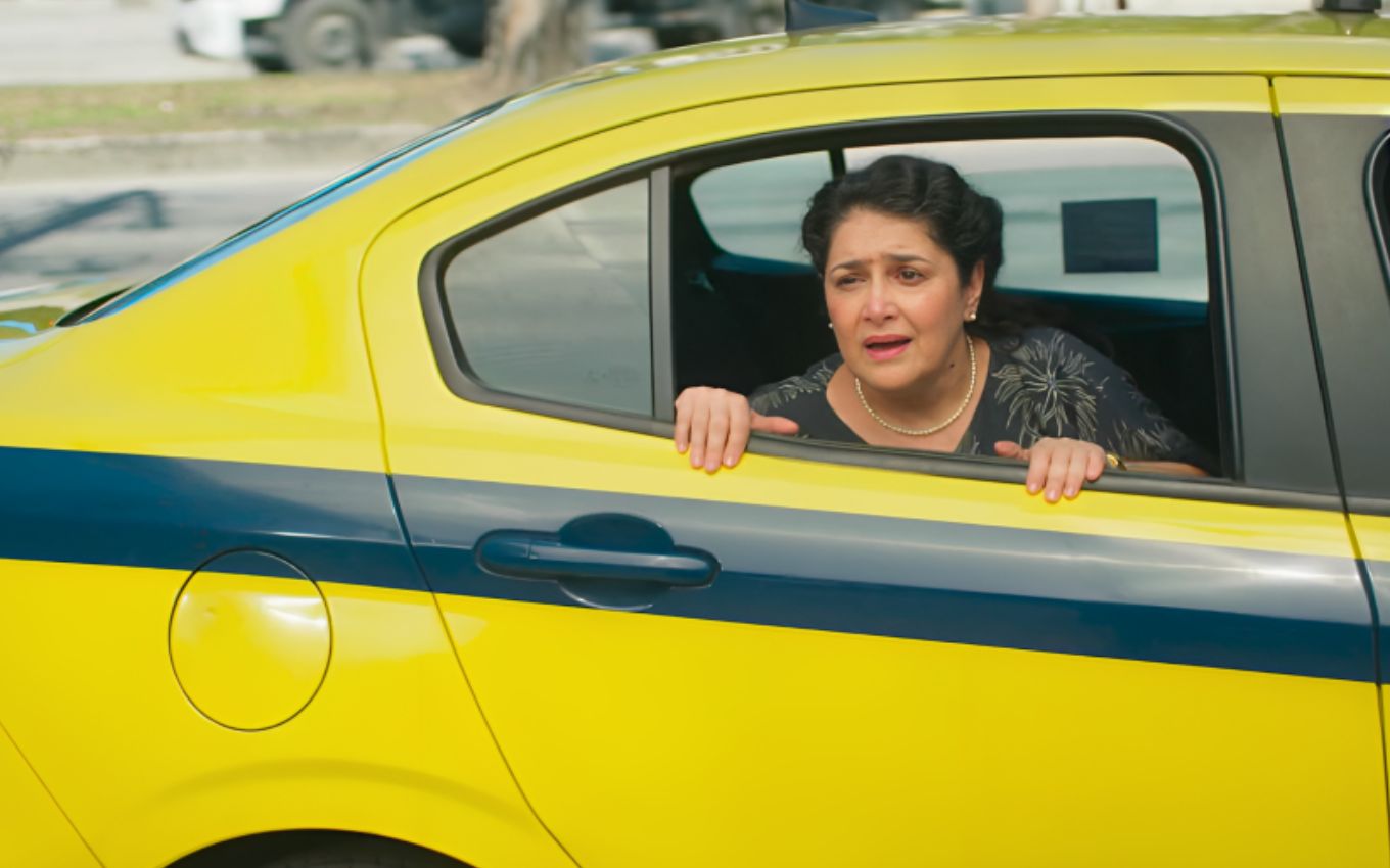 Inez Viana como Angelina dentro de um táxi em cena de Terra e Paixão